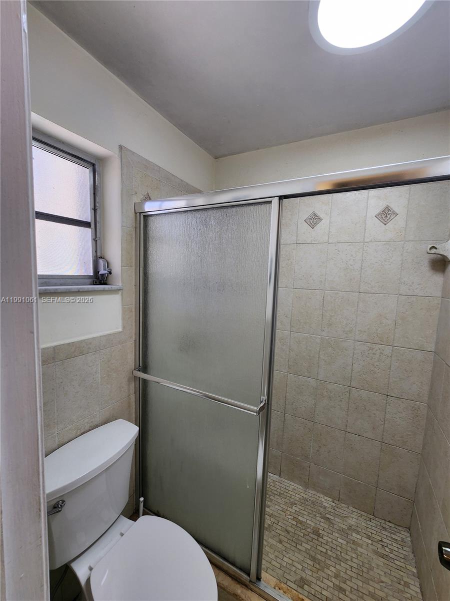 120 Southwest 80th Avenue Miami, FL 33144 - Photo 10 of 10 a bathroom with a toilet and a shower