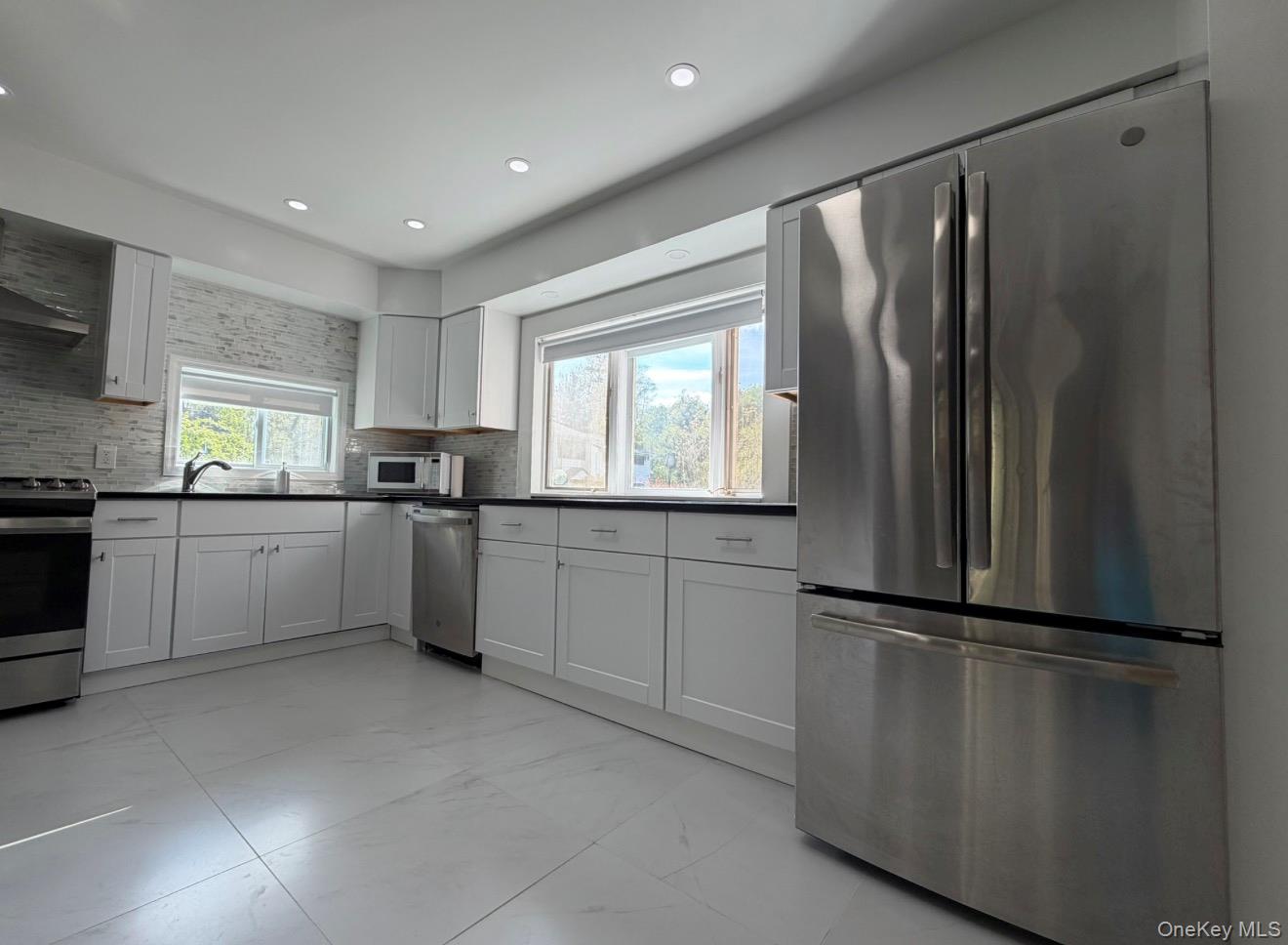 60 Medallion Road Kiamesha Lake, NY 12751 - Photo 17 of 44 a kitchen with stainless steel appliances granite countertop a refrigerator sink and cabinets