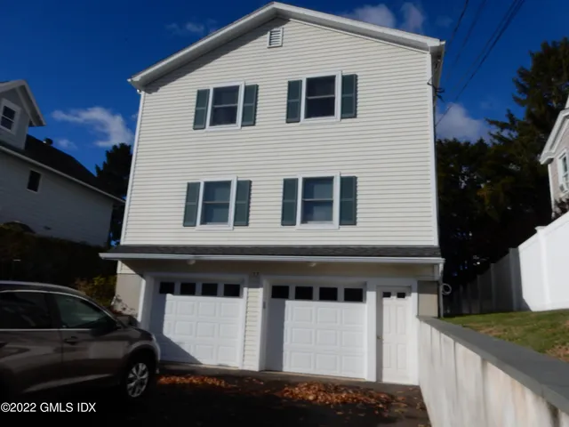 a front view of a house with a garage