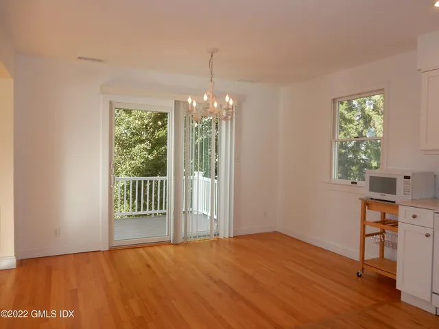a view of a room with wooden floor and a window