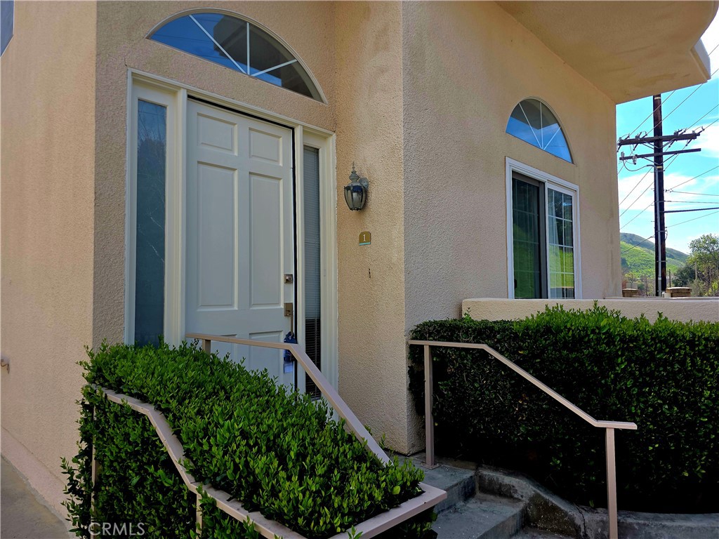 5340 Las Virgenes Road, Unit 1 Calabasas, CA 91302 - Photo 1 of 23 a front view of a house with plants