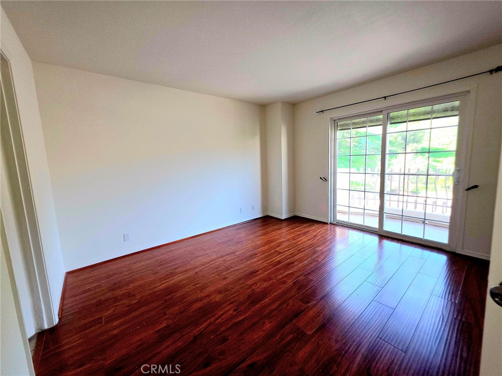 5340 Las Virgenes Road, Unit 1 Calabasas, CA 91302 - Photo 15 of 23 a view of an empty room with wooden floor and a window