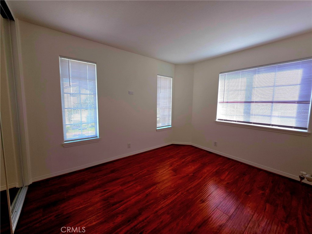 5340 Las Virgenes Road, Unit 1 Calabasas, CA 91302 - Photo 17 of 23 a view of an empty room with wooden floor and a window