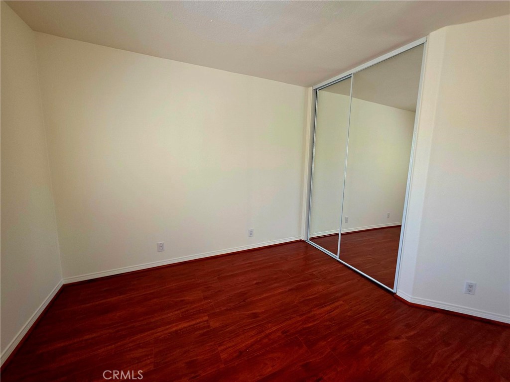 5340 Las Virgenes Road, Unit 1 Calabasas, CA 91302 - Photo 20 of 23 an empty room with wooden floor and white door