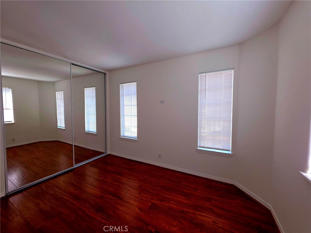 5340 Las Virgenes Road, Unit 1 Calabasas, CA 91302 - Photo 22 of 23 a view of an empty room with wooden floor and a window