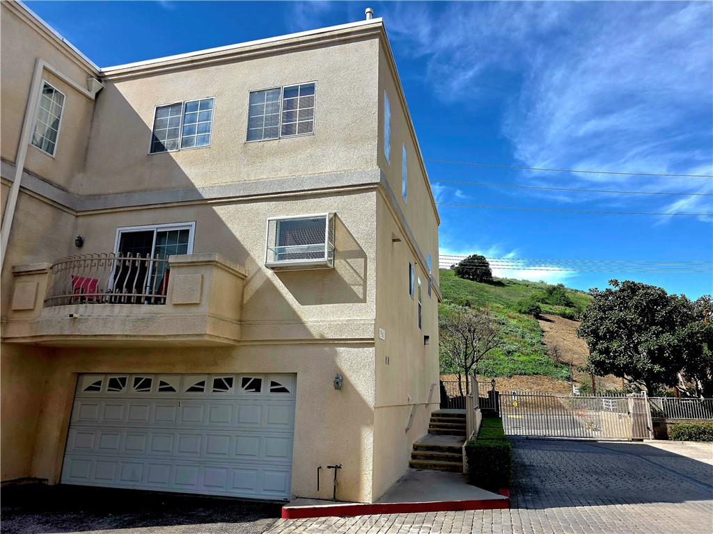 5340 Las Virgenes Road, Unit 1 Calabasas, CA 91302 - Photo 3 of 23 a view of a white house with large windows