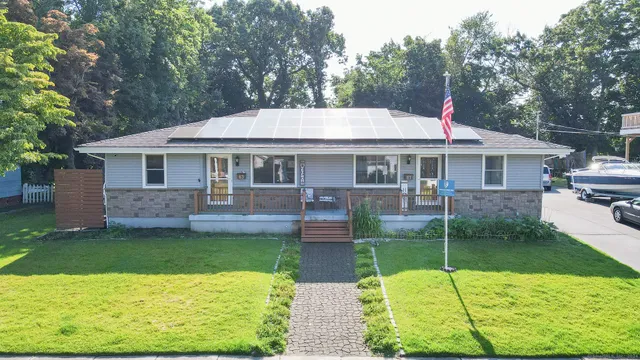 a view of a house with a yard patio and swimming pool