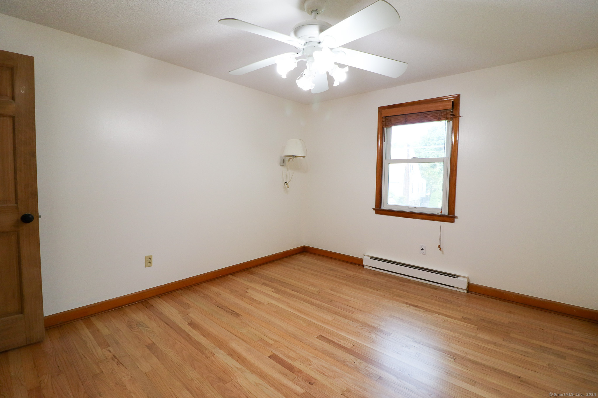 63 Home Avenue Meriden, CT 06451 - Photo 11 of 26 an empty room with wooden floor chandelier fan and windows