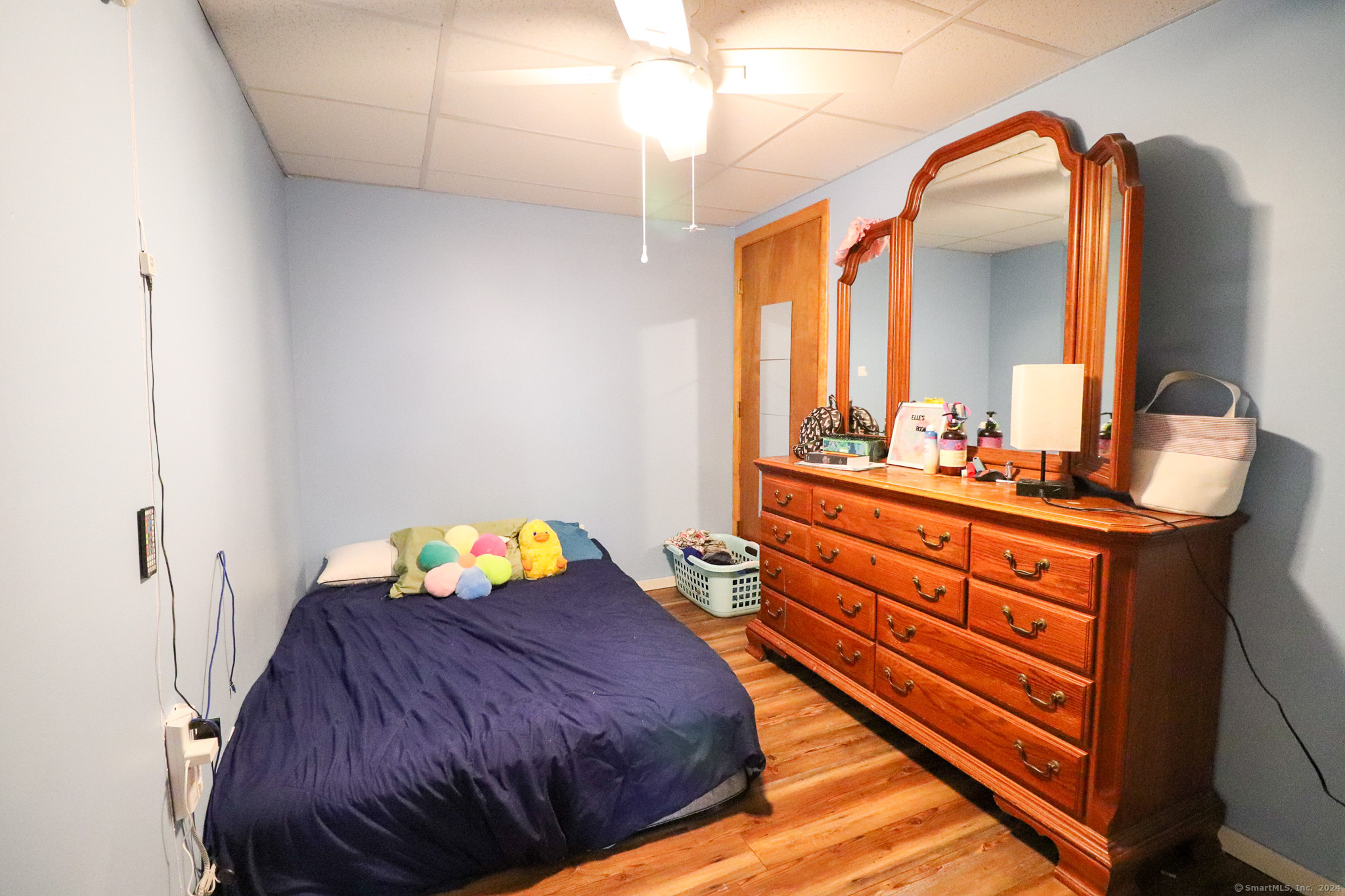 63 Home Avenue Meriden, CT 06451 - Photo 16 of 26 a bedroom with a bed and a mirror on the dresser