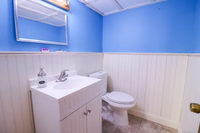 a bathroom with a sink a toilet and mirror