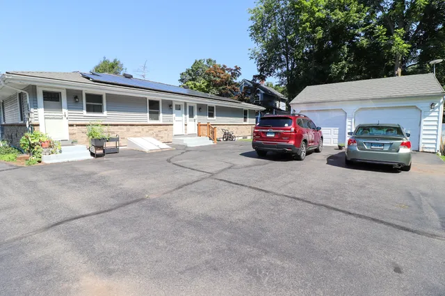 a view of a car parked in front of a house