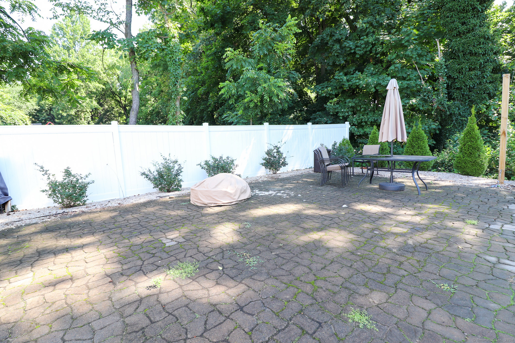 63 Home Avenue Meriden, CT 06451 - Photo 25 of 26 a backyard of a house with table and chairs