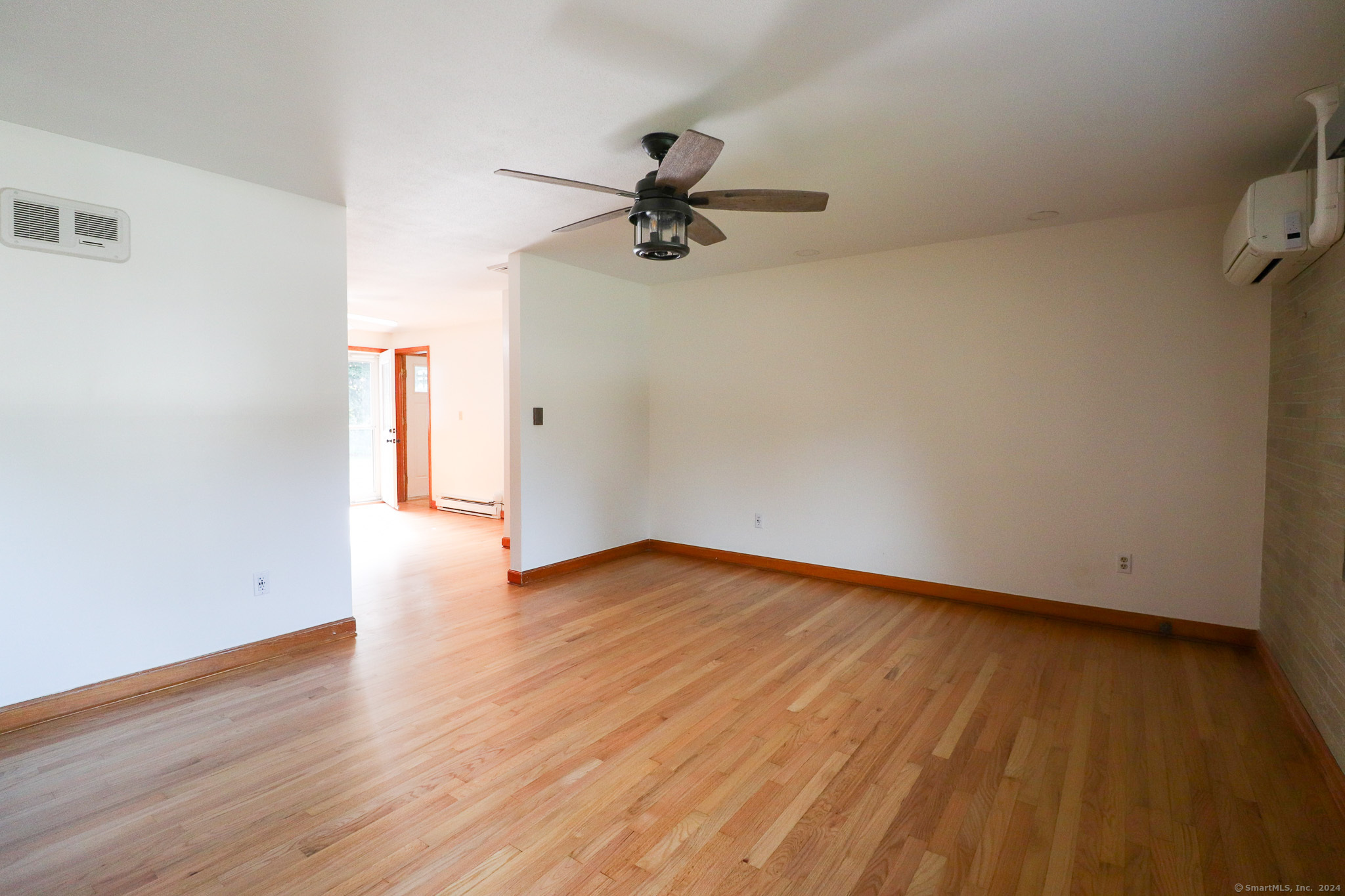63 Home Avenue Meriden, CT 06451 - Photo 4 of 26 a view of an empty room with wooden floor and a ceiling fan