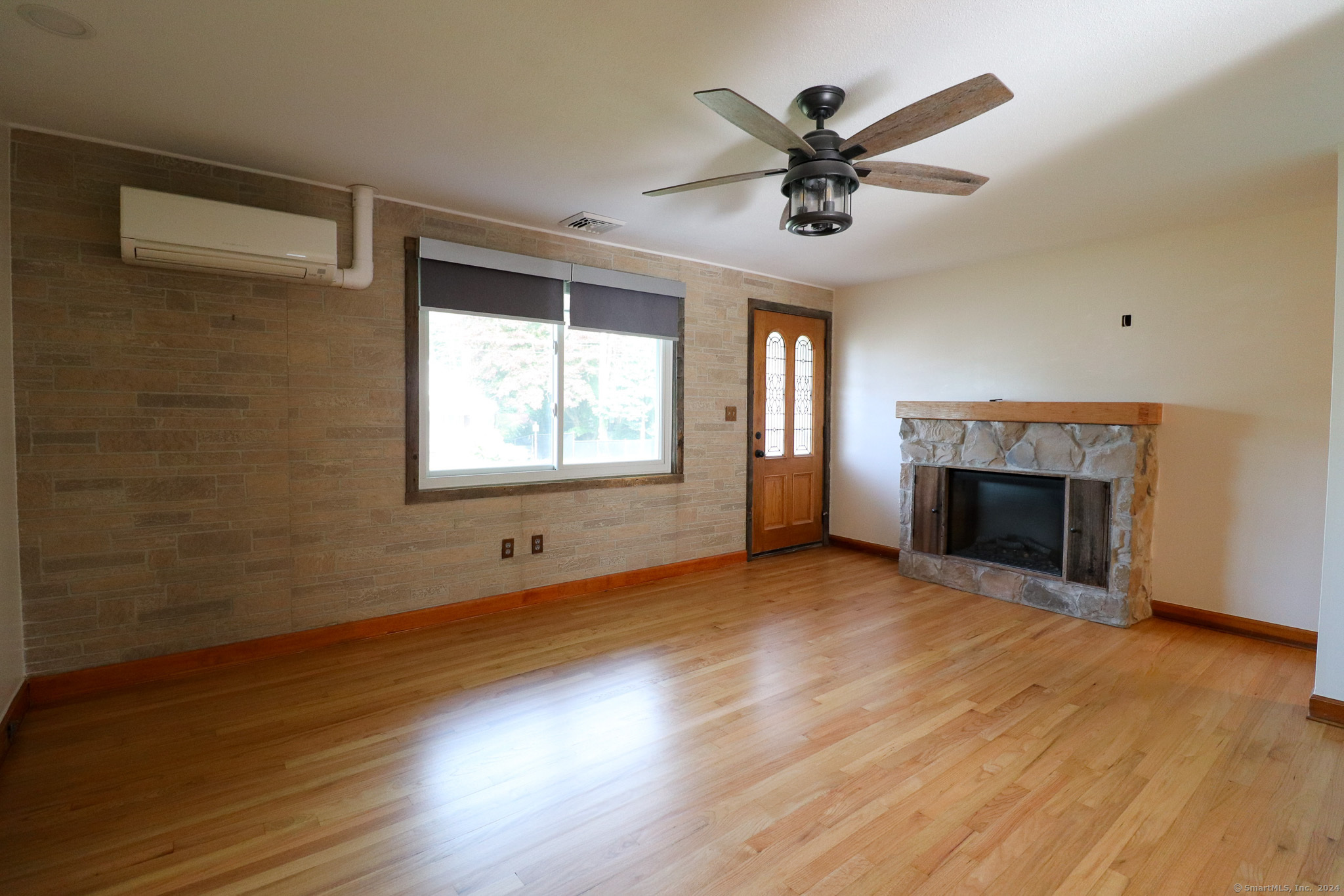 63 Home Avenue Meriden, CT 06451 - Photo 6 of 26 an empty room with wooden floor a ceiling fan and windows