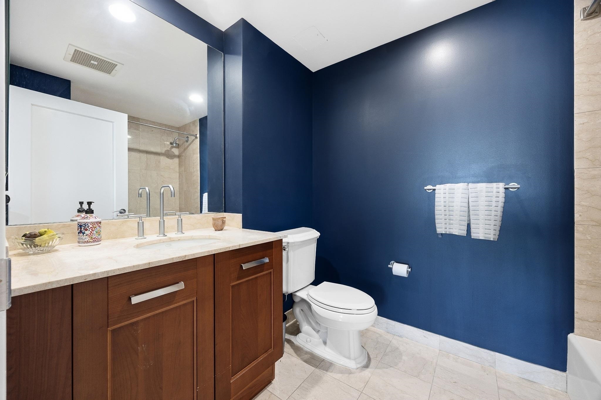 8100 River Road, Unit 1203 North Bergen, NJ 07047 - Photo 11 of 31 a bathroom with a granite countertop sink a toilet and a mirror