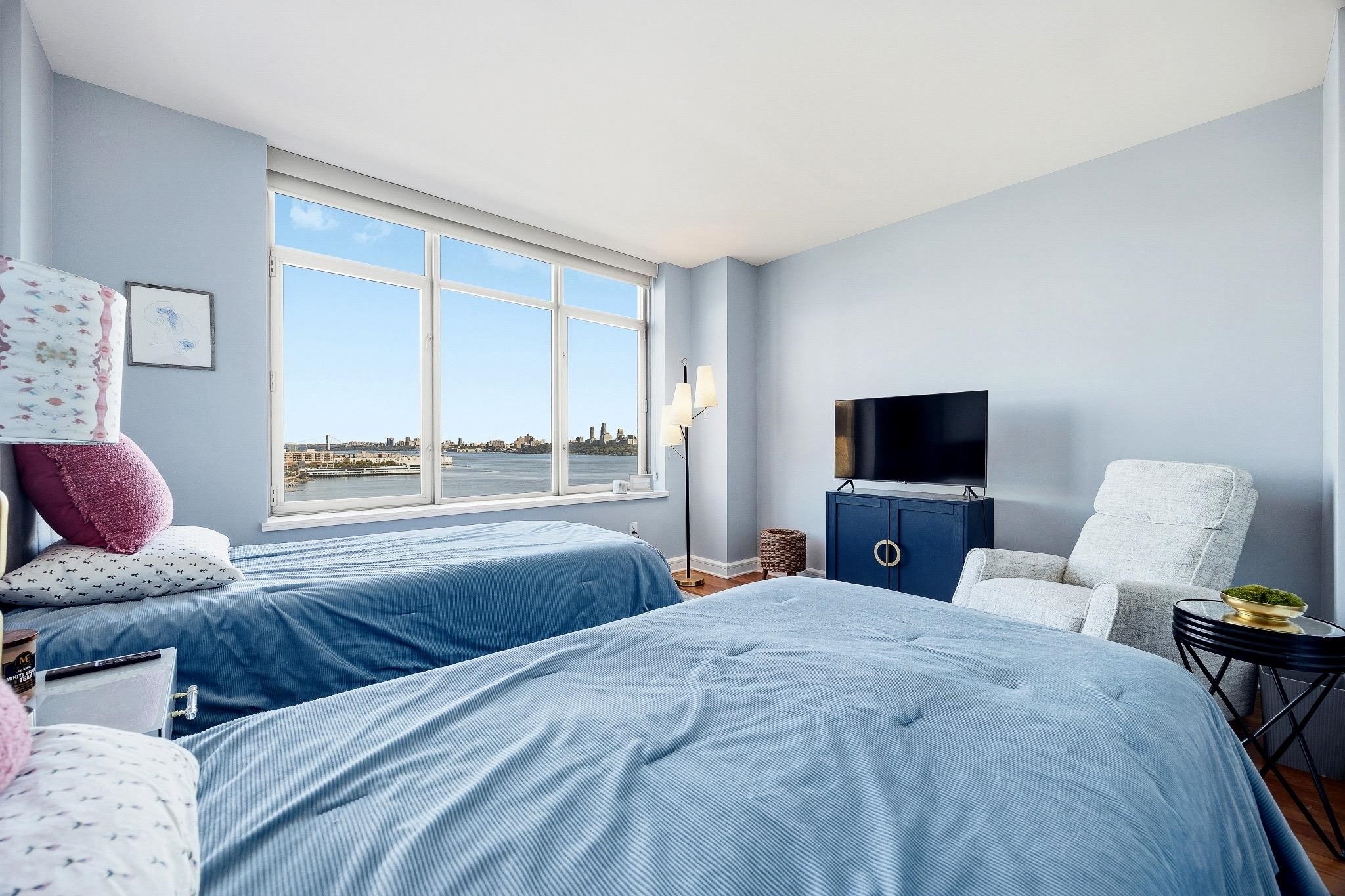 8100 River Road, Unit 1203 North Bergen, NJ 07047 - Photo 12 of 31 a bedroom with a bed and a television