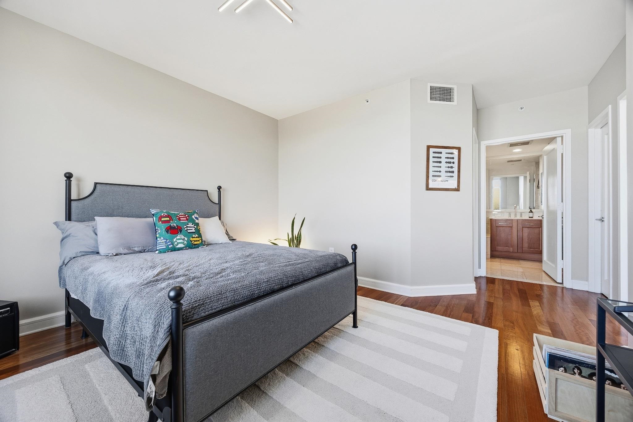 8100 River Road, Unit 1203 North Bergen, NJ 07047 - Photo 14 of 31 a bedroom with a bed and wooden floor