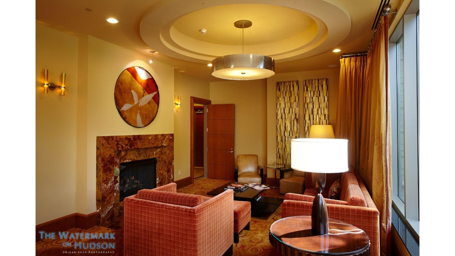 8100 River Road, Unit 1203 North Bergen, NJ 07047 - Photo 16 of 31 a living room with furniture a fireplace and a chandelier