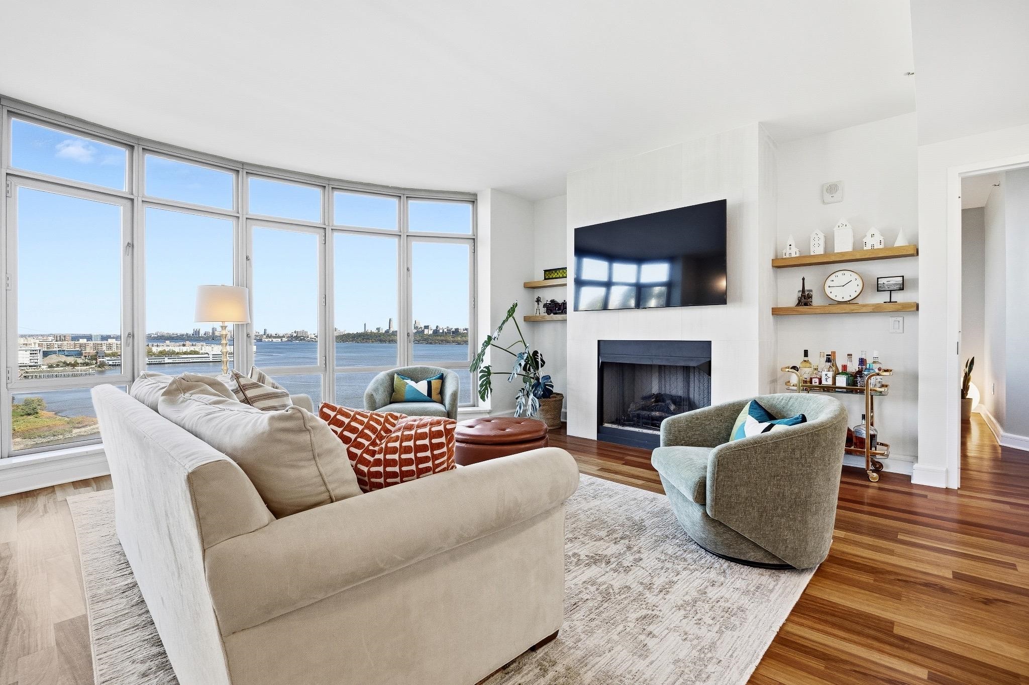 8100 River Road, Unit 1203 North Bergen, NJ 07047 - Photo 2 of 31 a living room with furniture and a fireplace