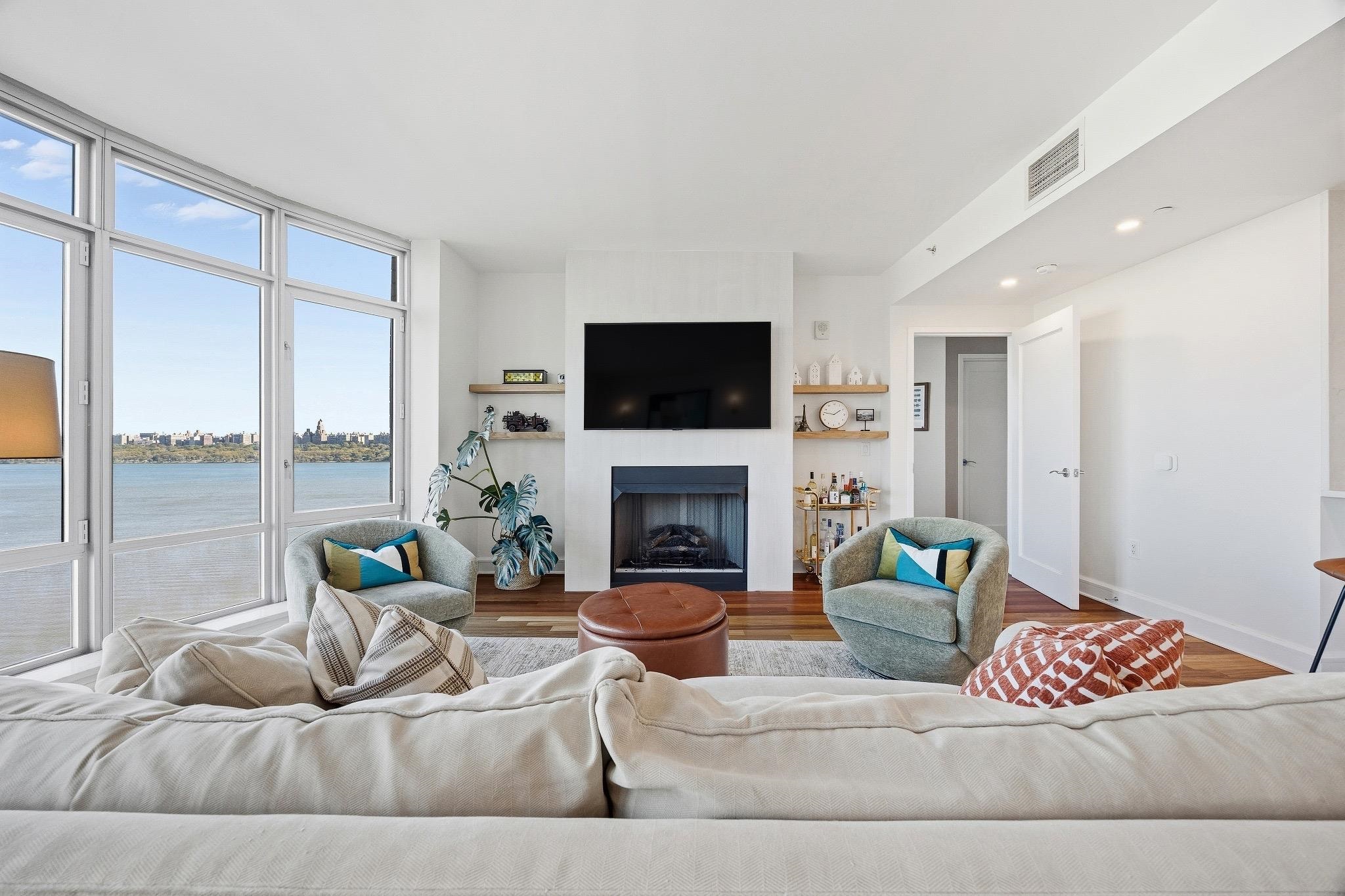 8100 River Road, Unit 1203 North Bergen, NJ 07047 - Photo 3 of 31 a living room with furniture and a fireplace