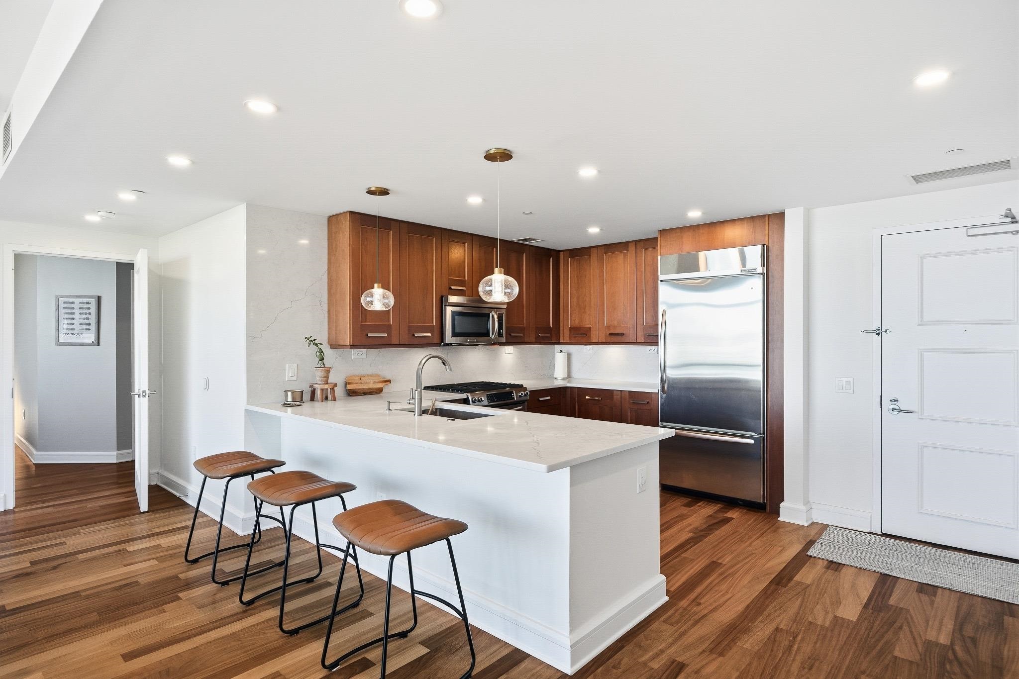 8100 River Road, Unit 1203 North Bergen, NJ 07047 - Photo 8 of 31 a kitchen with stainless steel appliances granite countertop a refrigerator and a stove top oven