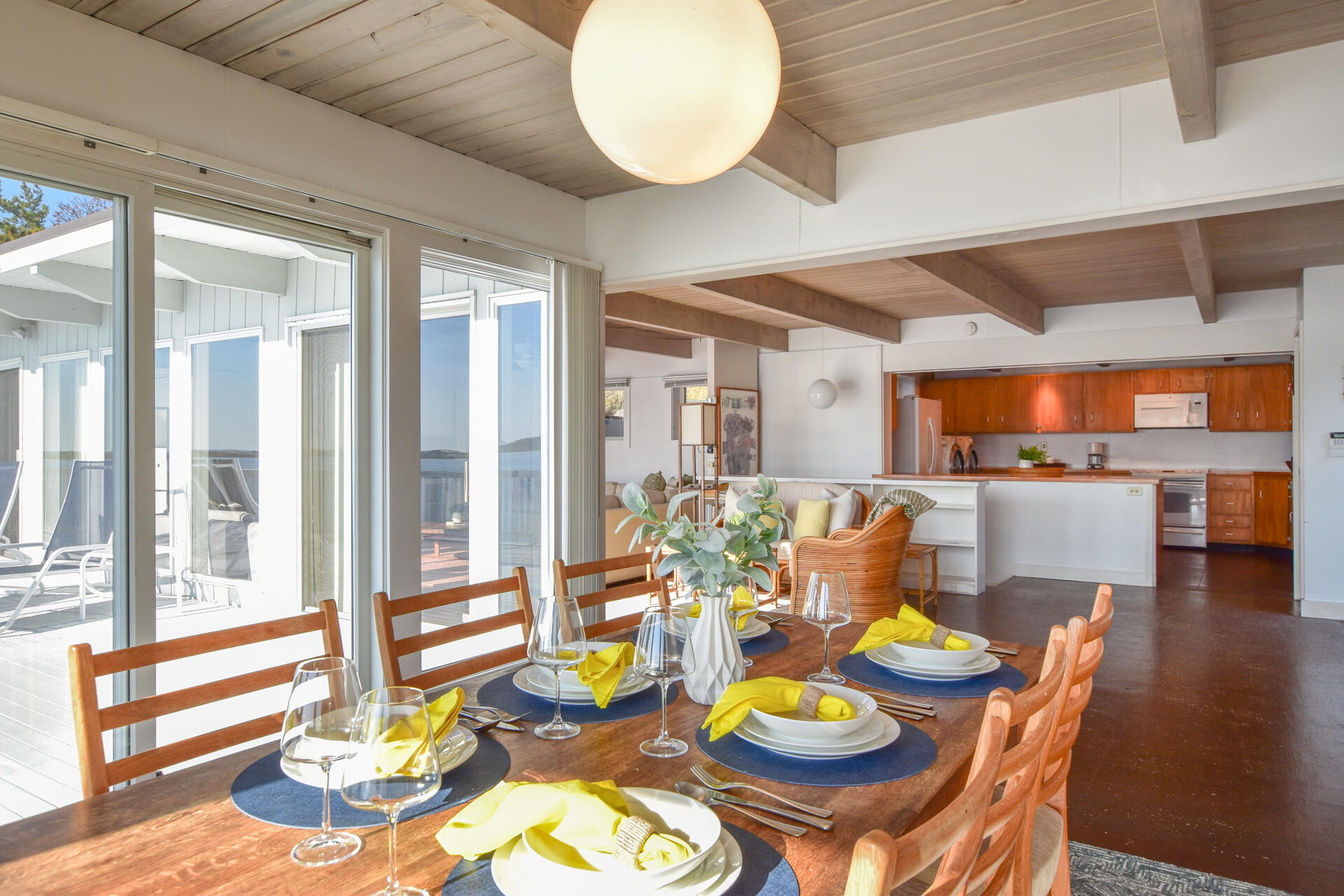 945 Chequessett Neck Road Wellfleet, MA 02667 - Photo 11 of 57 a view of a dining room with furniture a chandelier and wooden floor