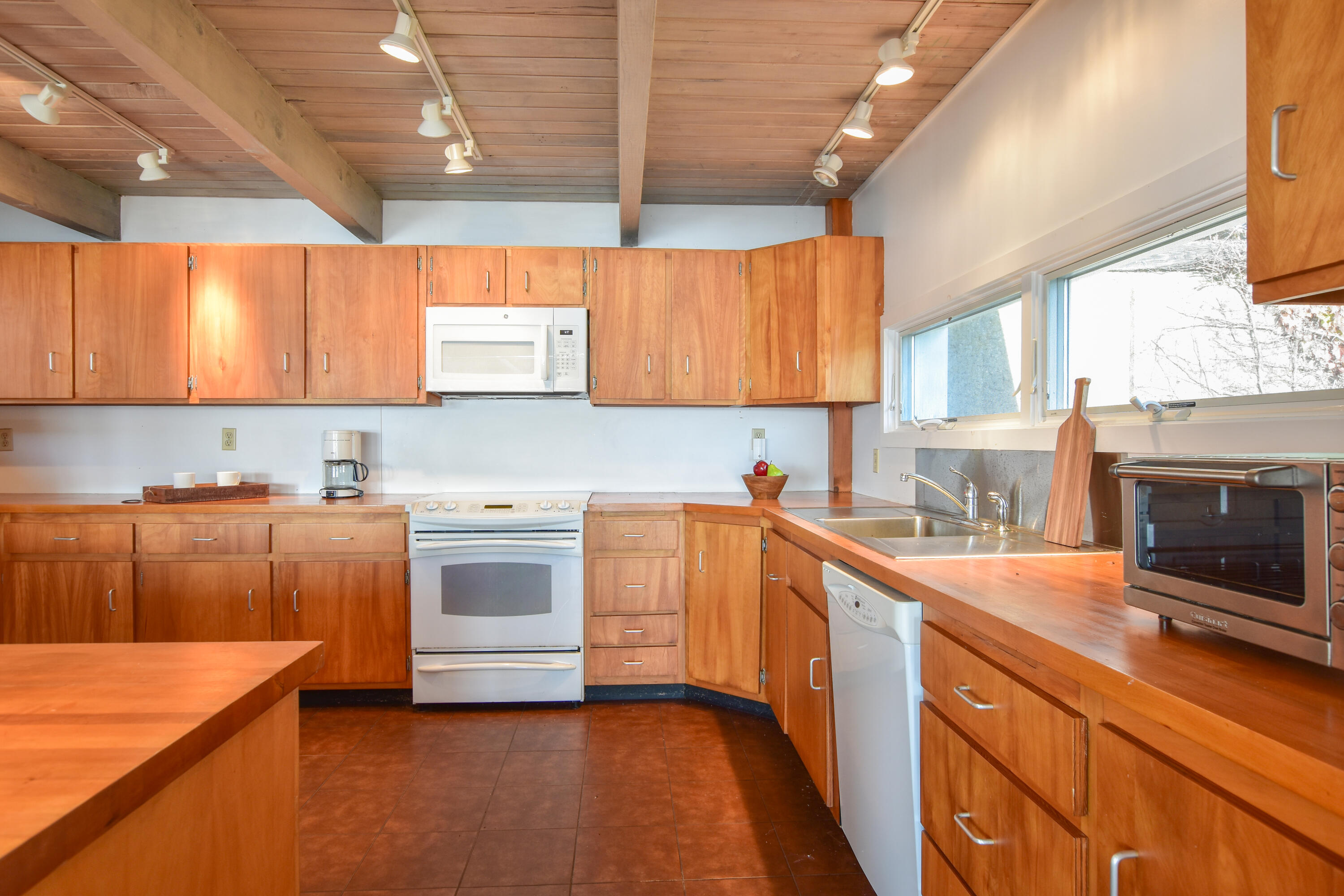 945 Chequessett Neck Road Wellfleet, MA 02667 - Photo 12 of 57 a kitchen with stainless steel appliances a stove sink and cabinets