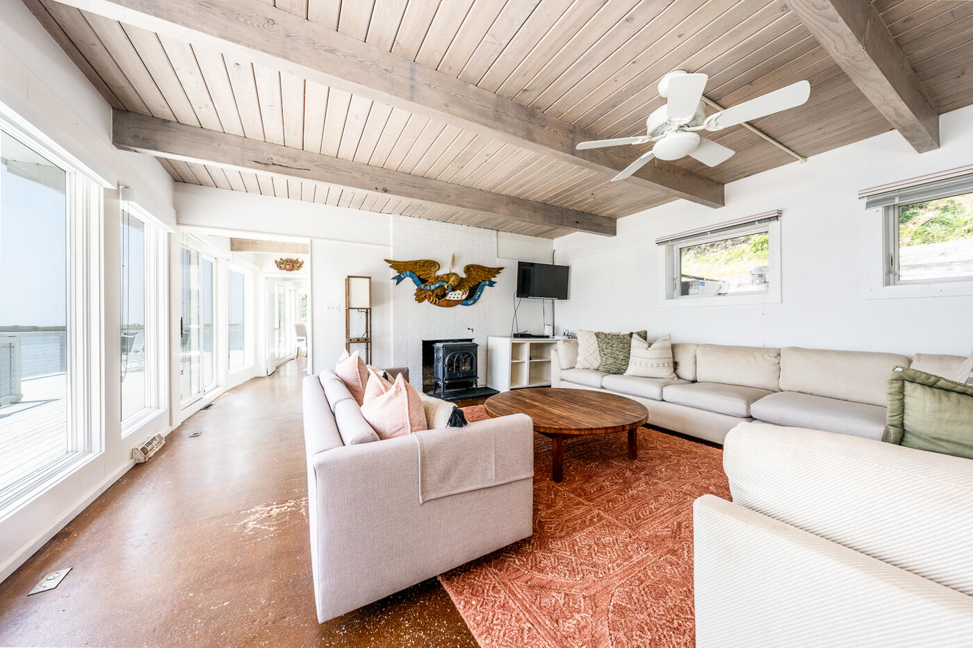 945 Chequessett Neck Road Wellfleet, MA 02667 - Photo 19 of 57 a living room with fireplace furniture and a large window