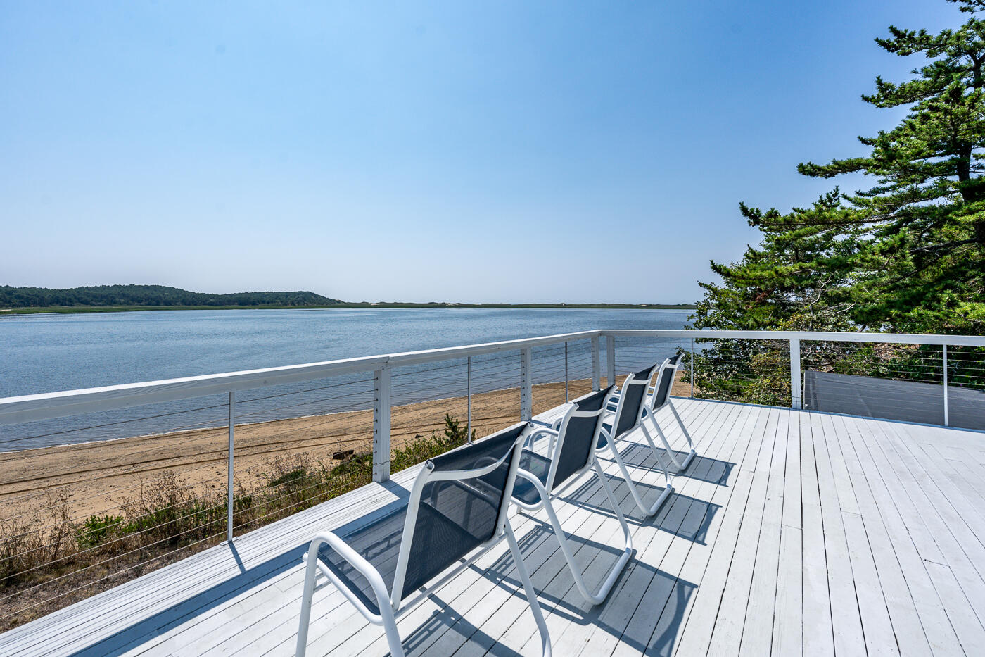 945 Chequessett Neck Road Wellfleet, MA 02667 - Photo 21 of 57 a view of a balcony with wooden floor and iron fence