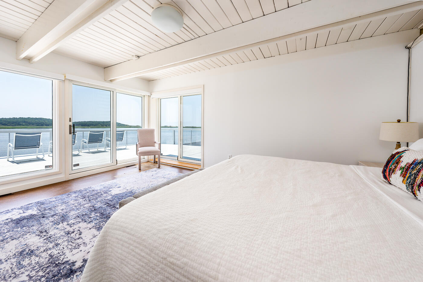 945 Chequessett Neck Road Wellfleet, MA 02667 - Photo 23 of 57 a spacious bedroom with a bed and a wooden floor