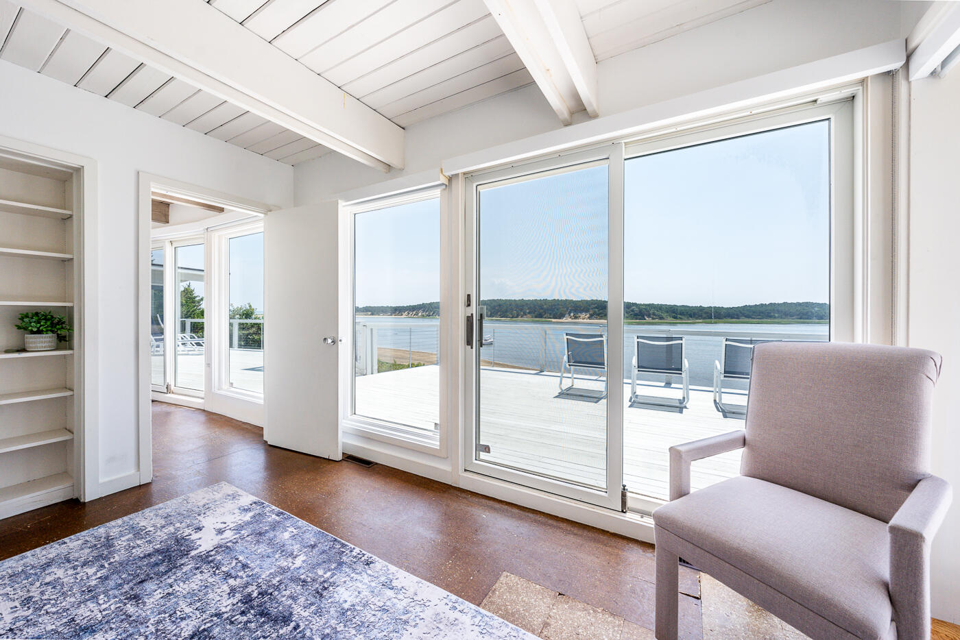 945 Chequessett Neck Road Wellfleet, MA 02667 - Photo 25 of 57 a living room with furniture and a large window