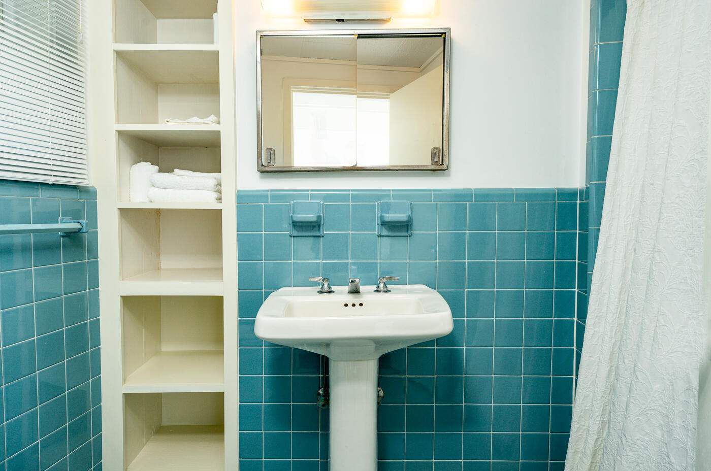 945 Chequessett Neck Road Wellfleet, MA 02667 - Photo 26 of 57 a bathroom with a sink a mirror and shower