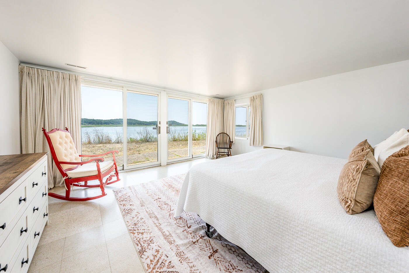 945 Chequessett Neck Road Wellfleet, MA 02667 - Photo 28 of 57 a bedroom with a bed and a large window