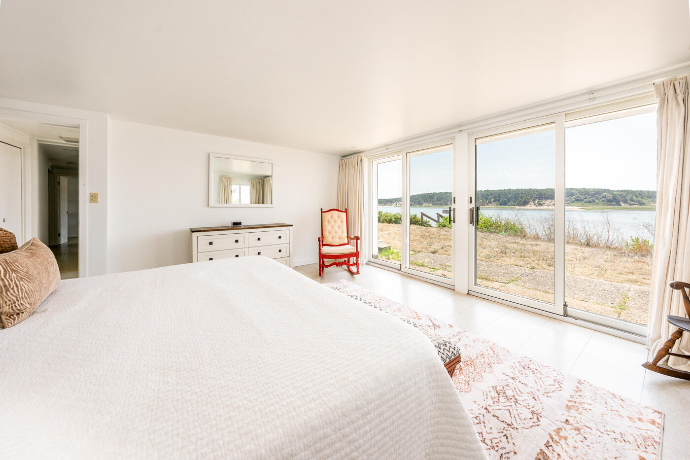 945 Chequessett Neck Road Wellfleet, MA 02667 - Photo 29 of 57 a spacious bedroom with a large bed and a large window