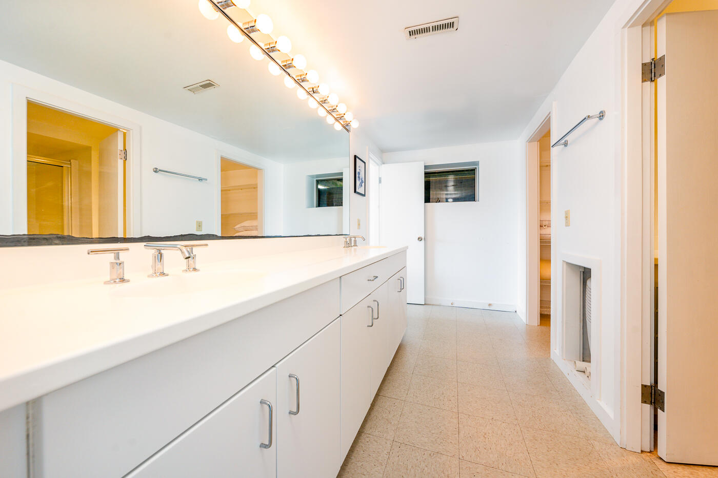 945 Chequessett Neck Road Wellfleet, MA 02667 - Photo 31 of 57 a spacious bathroom with a double vanity sink and a mirror