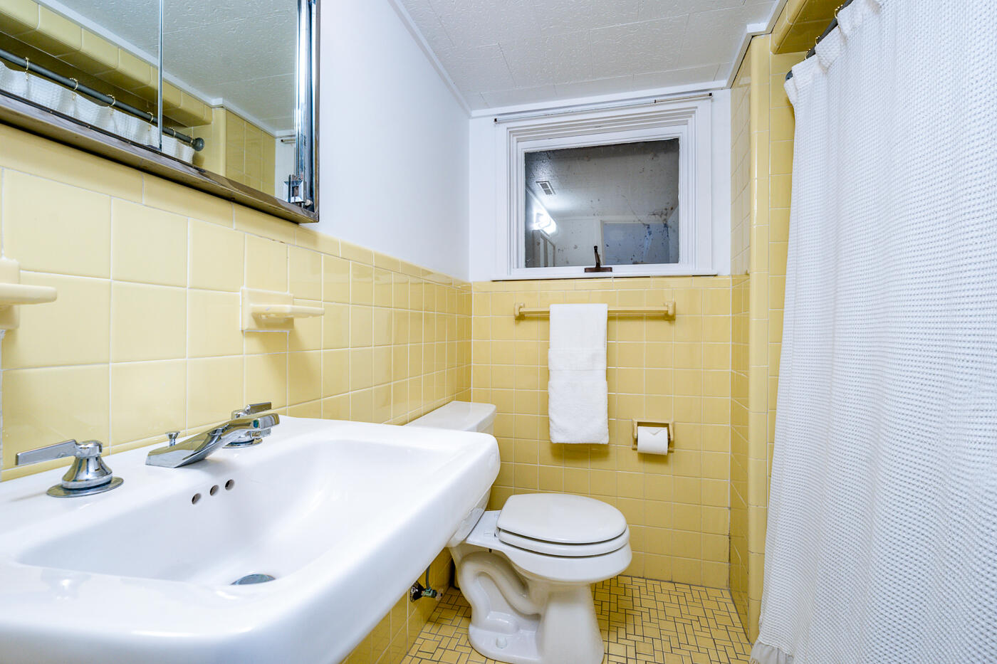 945 Chequessett Neck Road Wellfleet, MA 02667 - Photo 37 of 57 a bathroom with a sink and mirror with toilet
