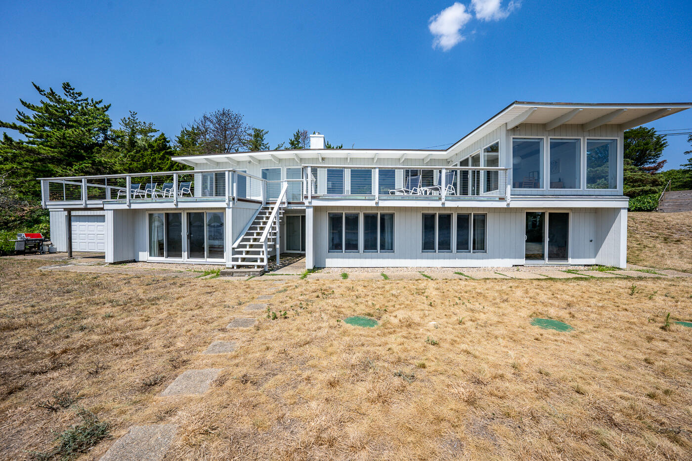 945 Chequessett Neck Road Wellfleet, MA 02667 - Photo 40 of 57 a front view of a house with a yard