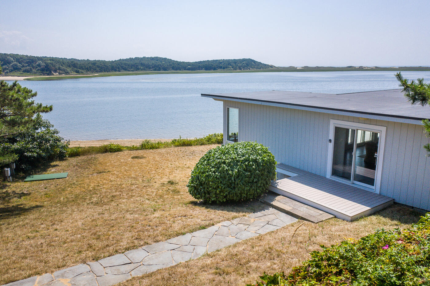 945 Chequessett Neck Road Wellfleet, MA 02667 - Photo 51 of 57 a front view of a house with a yard