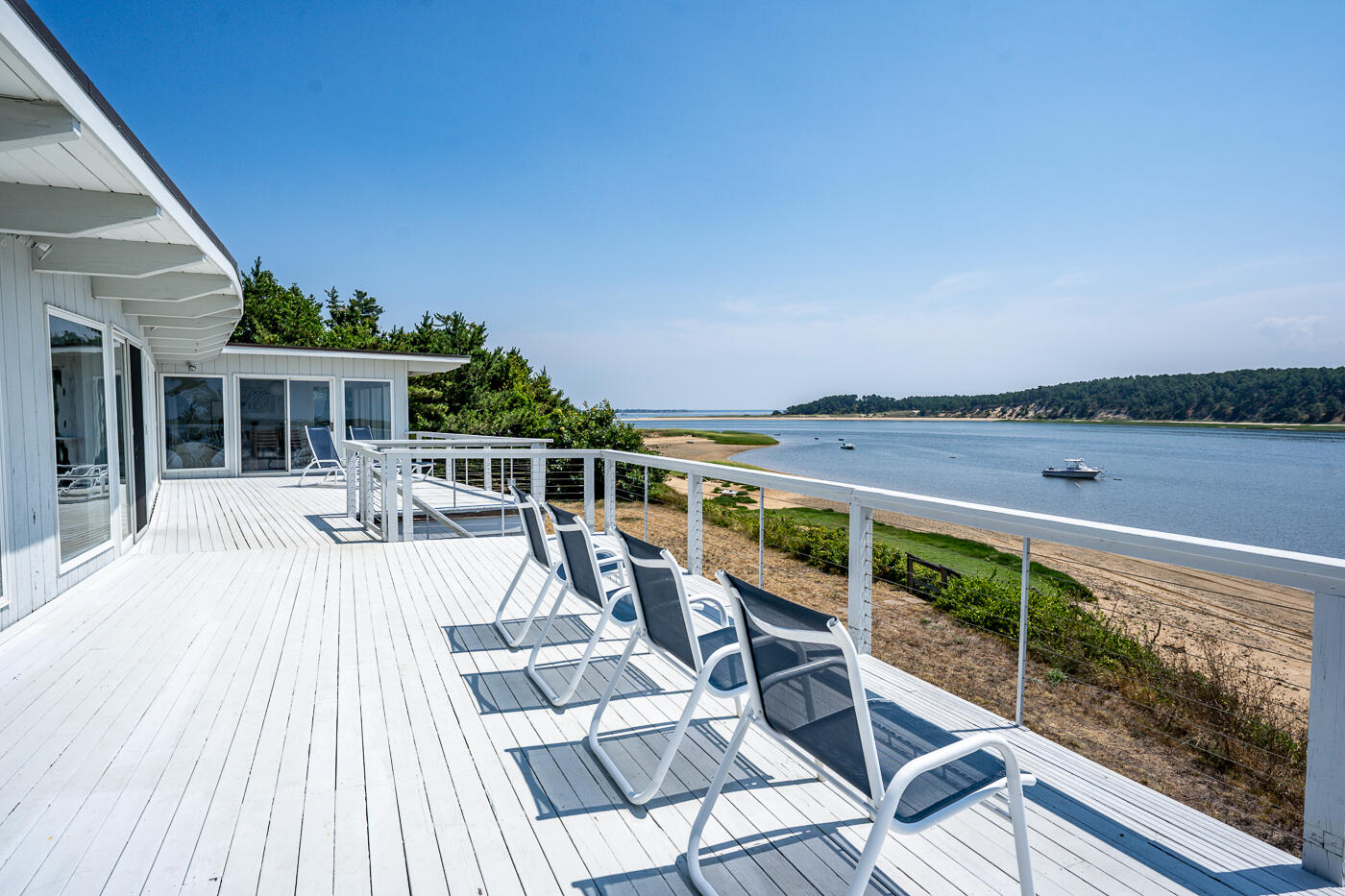945 Chequessett Neck Road Wellfleet, MA 02667 - Photo 53 of 57 a view of a balcony with lake view and wooden floor