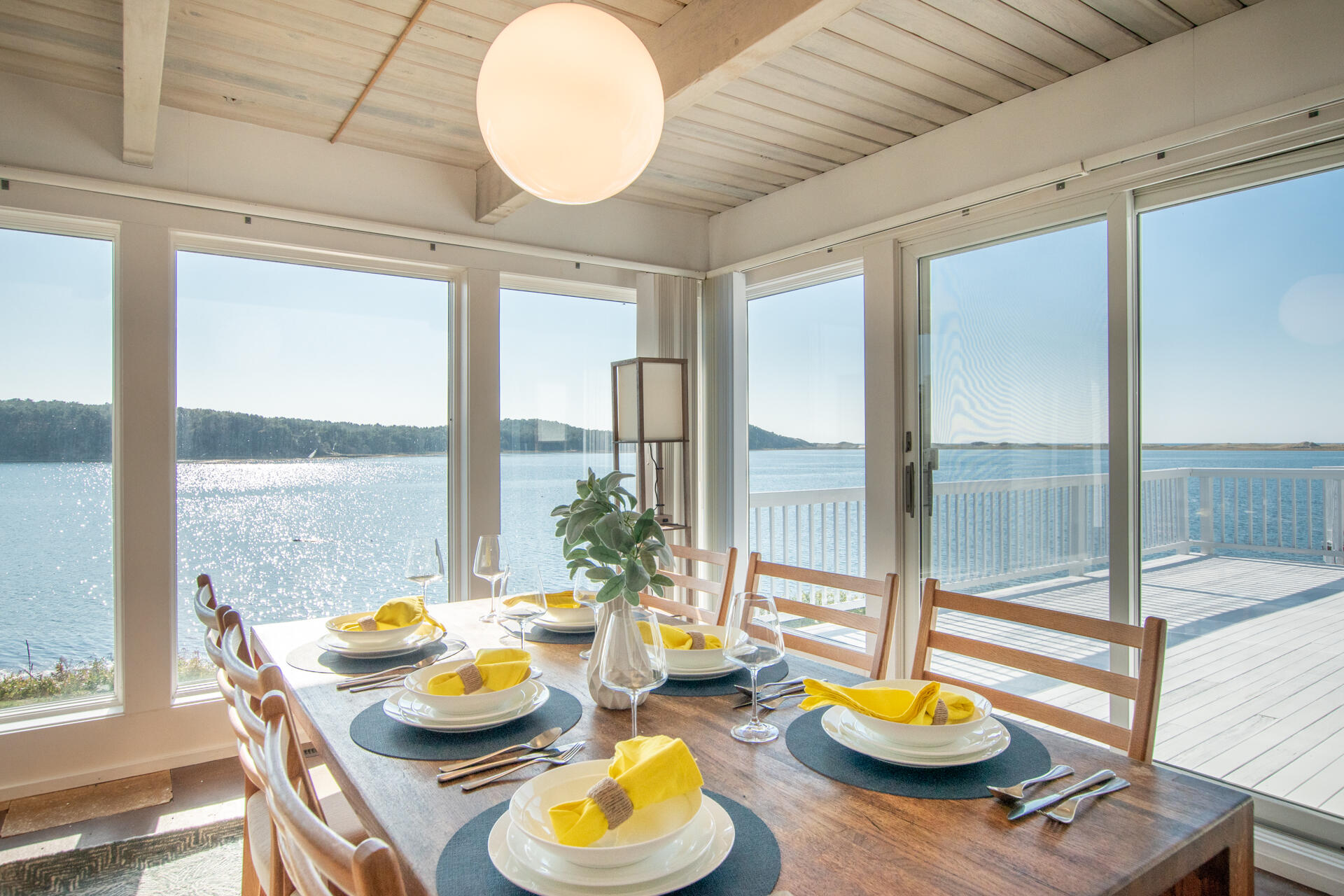 945 Chequessett Neck Road Wellfleet, MA 02667 - Photo 6 of 57 a view of a dining room with furniture a chandelier and wooden floor