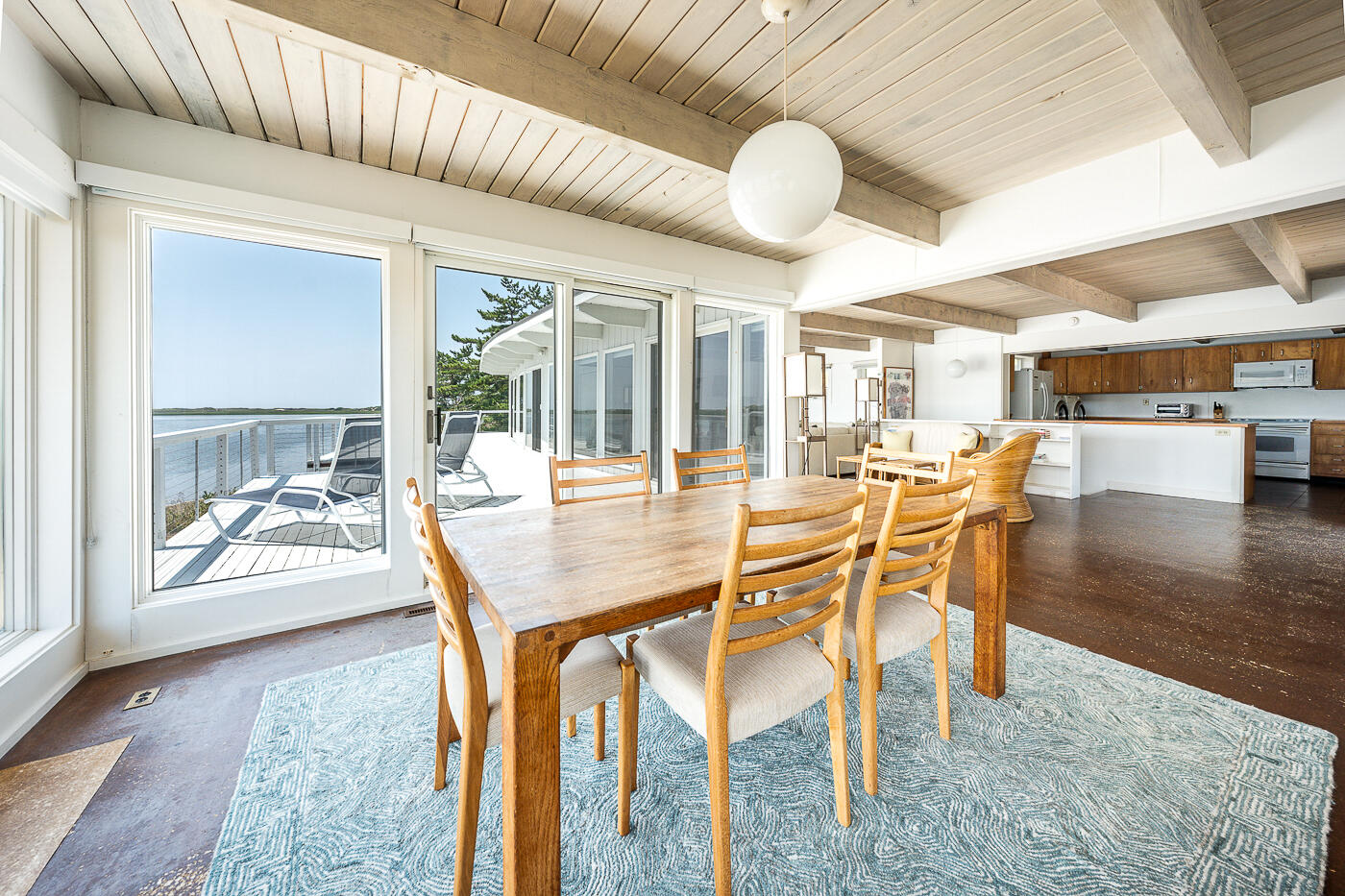 945 Chequessett Neck Road Wellfleet, MA 02667 - Photo 10 of 57 a dining area with furniture a chandelier and wooden floor
