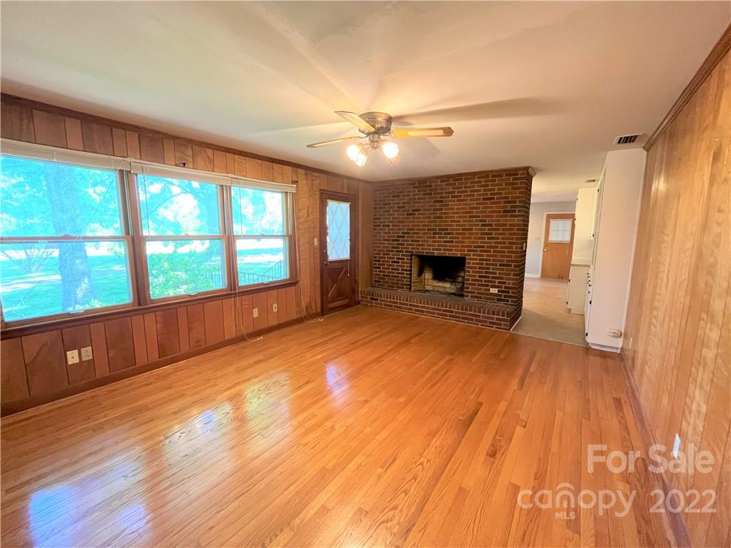 506 8th Street Southwest Conover, NC 28613 - Photo 13 of 38 wooden floor fireplace and windows in an empty room