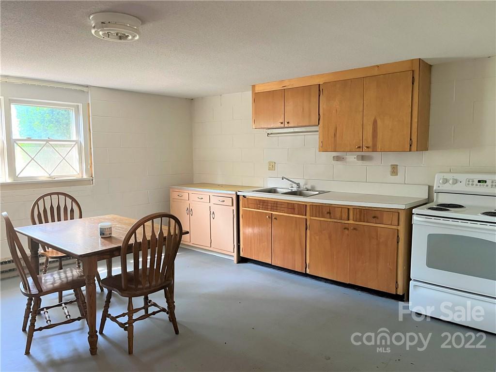 506 8th Street Southwest Conover, NC 28613 - Photo 26 of 38 a kitchen with a stove a sink and a refrigerator