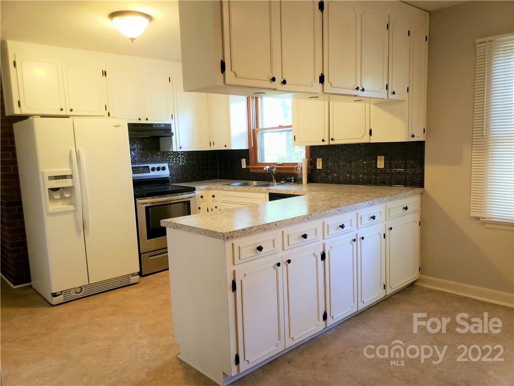 506 8th Street Southwest Conover, NC 28613 - Photo 8 of 38 a kitchen with stainless steel appliances a refrigerator sink and cabinets