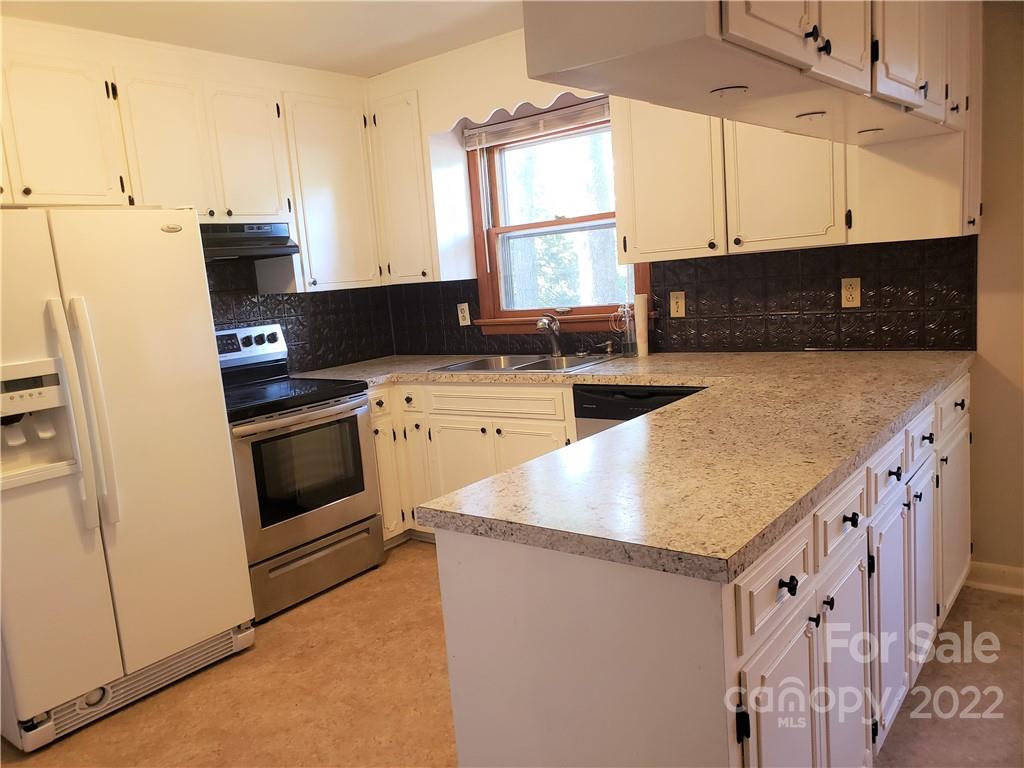 506 8th Street Southwest Conover, NC 28613 - Photo 9 of 38 a kitchen with stainless steel appliances granite countertop a stove a sink and a microwave