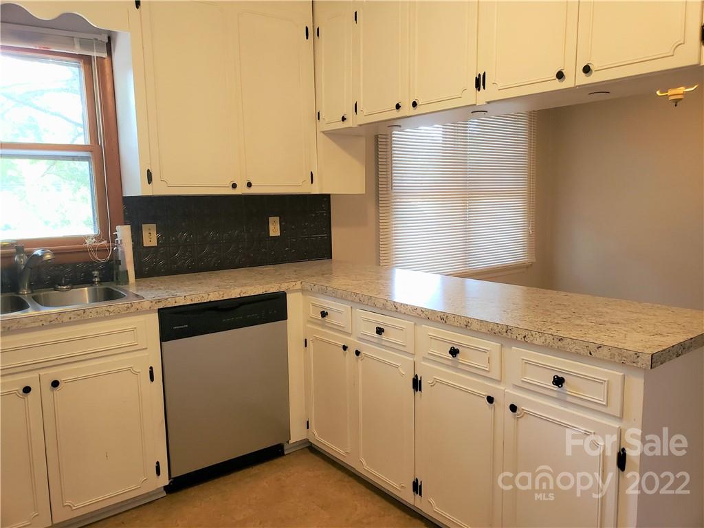 506 8th Street Southwest Conover, NC 28613 - Photo 10 of 38 a kitchen with granite countertop white cabinets and white appliances