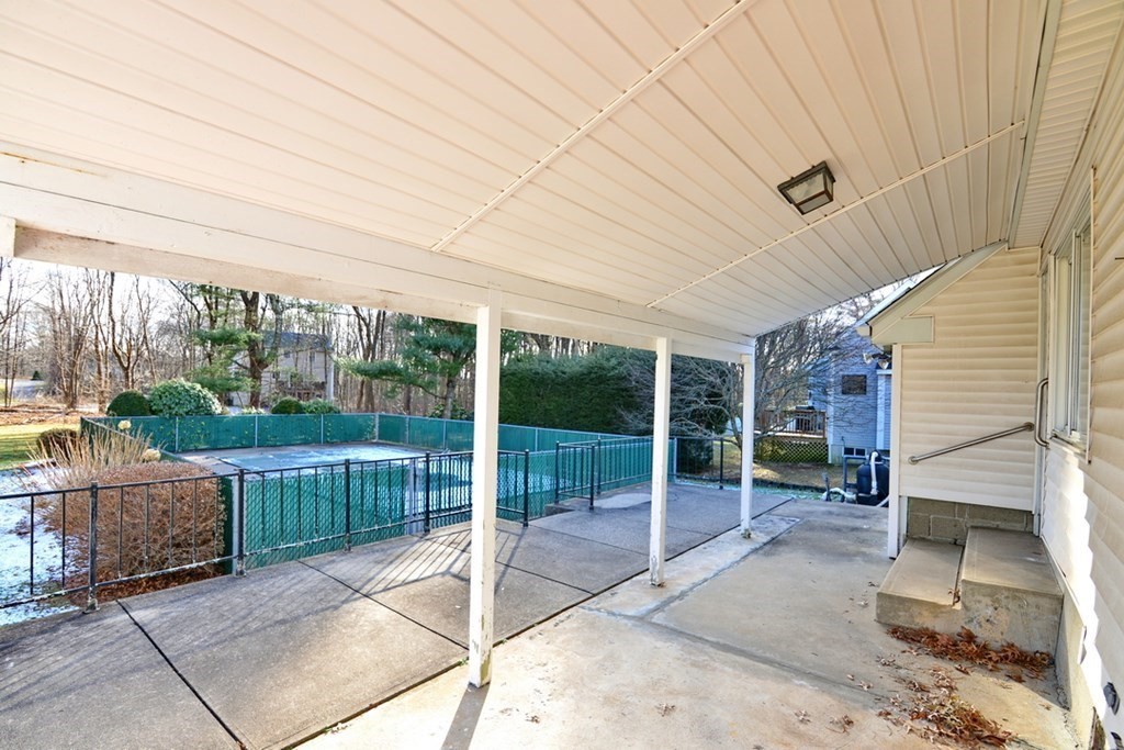 44 Everett Street Franklin, MA 02038 - Photo 23 of 31 a view of a patio with a table and chairs and floor to ceiling window