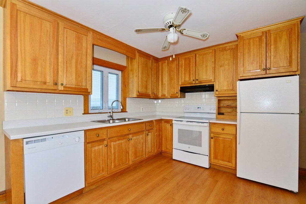 44 Everett Street Franklin, MA 02038 - Photo 4 of 31 a kitchen with stainless steel appliances granite countertop a sink a stove a refrigerator with grey cabinets