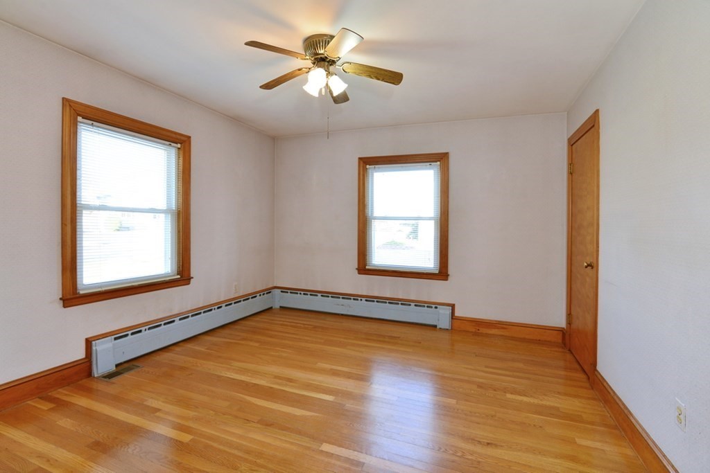 44 Everett Street Franklin, MA 02038 - Photo 8 of 31 a view of an empty room with a window and wooden floor