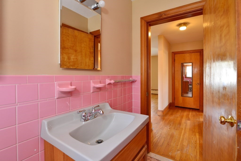 44 Everett Street Franklin, MA 02038 - Photo 10 of 31 a bathroom with a sink a toilet and mirror